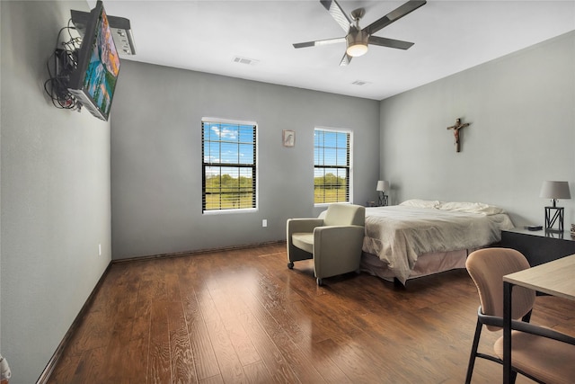 bedroom with ceiling fan and dark hardwood / wood-style flooring