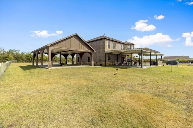 back of property with a yard and a patio