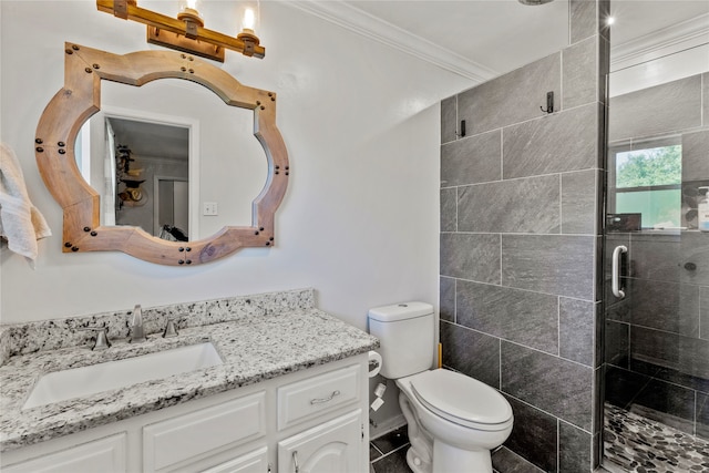 bathroom with vanity, tile patterned floors, crown molding, toilet, and a shower with door