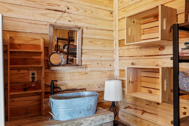 bathroom featuring wood walls and wood-type flooring