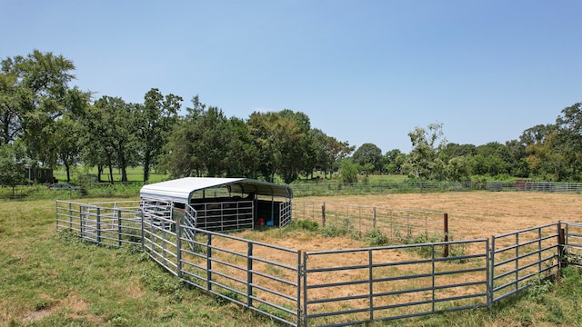 view of yard with an outdoor structure and a rural view