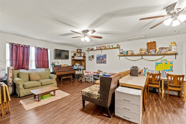 living room with wood-type flooring and ceiling fan