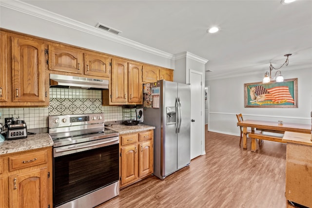 kitchen with decorative backsplash, stainless steel appliances, light hardwood / wood-style flooring, and ornamental molding