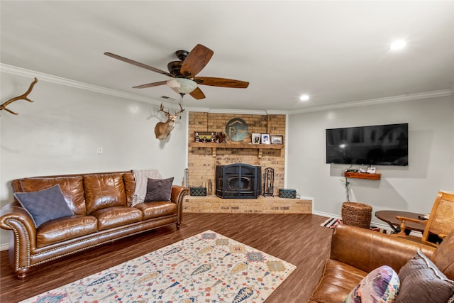 living room featuring hardwood / wood-style flooring, a fireplace, brick wall, ceiling fan, and ornamental molding