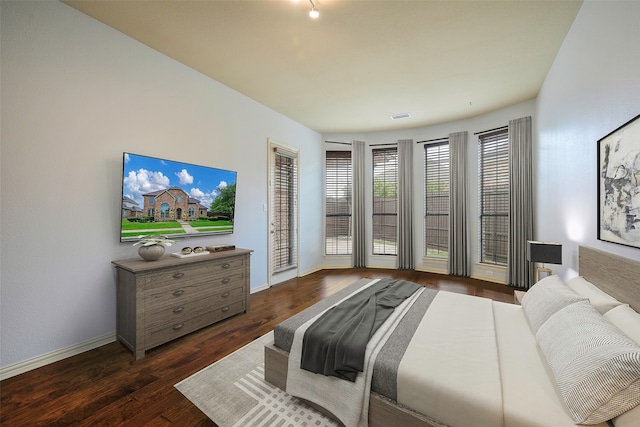 bedroom featuring access to outside and dark hardwood / wood-style floors