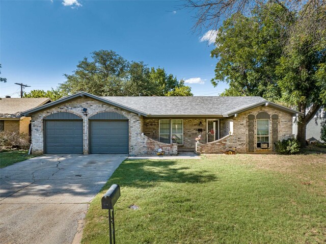 ranch-style house featuring a garage and a front yard