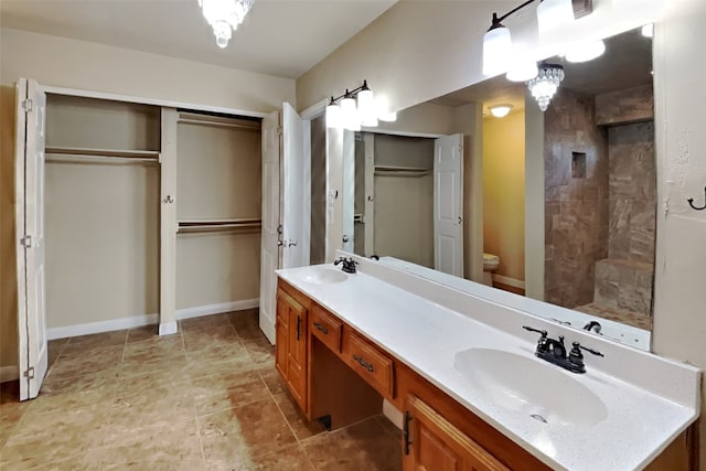 bathroom with toilet, vanity, and walk in shower