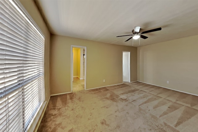 carpeted empty room with ceiling fan