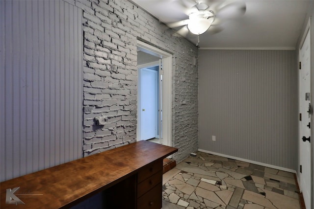 interior space with brick wall, light tile patterned floors, and ceiling fan