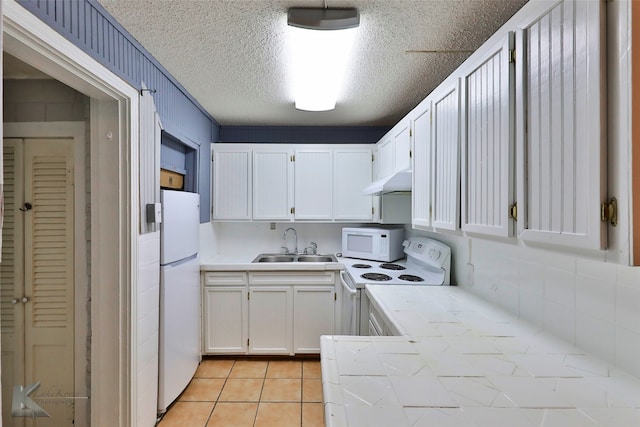 spare room with an AC wall unit, a textured ceiling, ceiling fan, and light hardwood / wood-style floors