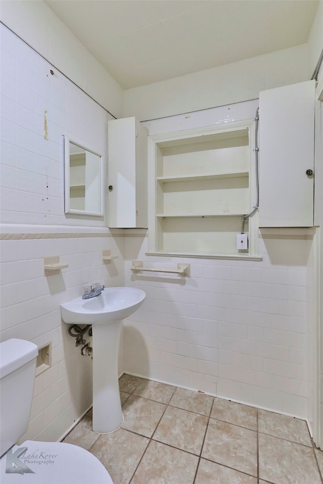 kitchen with white cabinetry, white appliances, sink, tile countertops, and light tile patterned floors