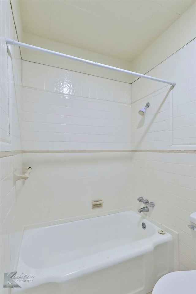 bathroom featuring shower / bath combination and toilet