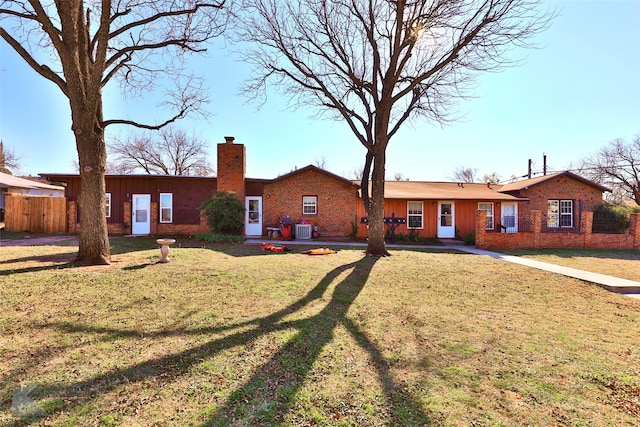 rear view of property with a yard