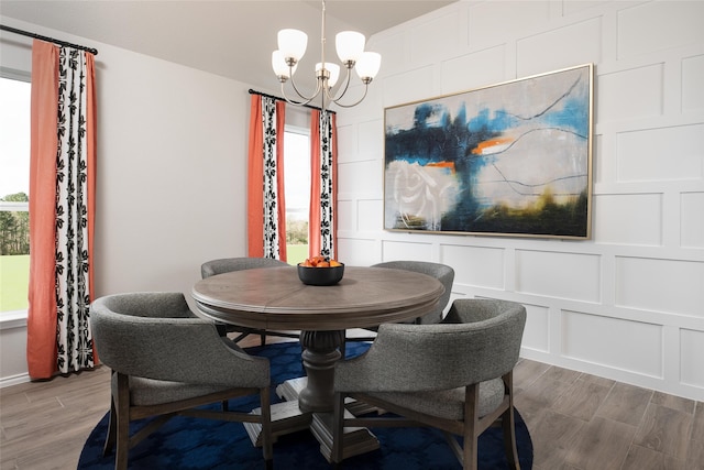 dining room with hardwood / wood-style flooring and a notable chandelier