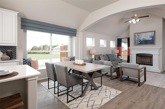 dining space featuring a wealth of natural light, lofted ceiling, ceiling fan, and light hardwood / wood-style flooring