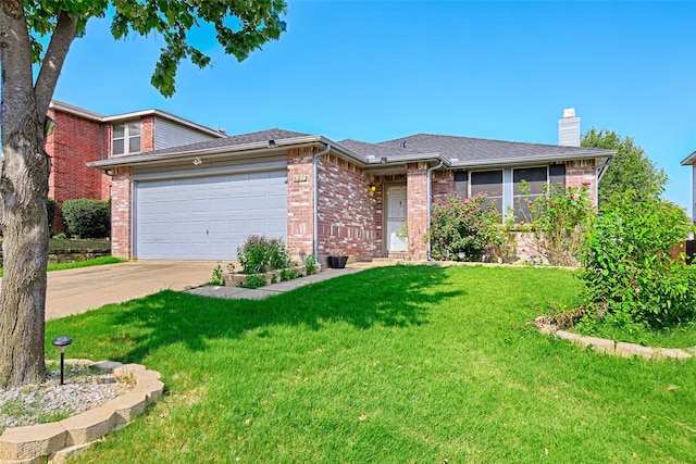 view of front of home with a front yard and a garage