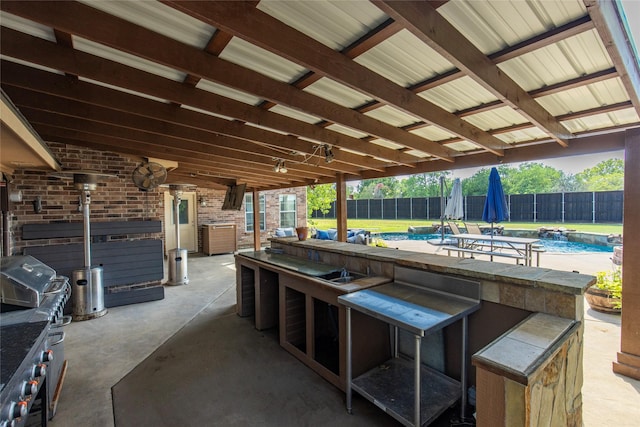 view of patio / terrace featuring outdoor dry bar, fence, and a fenced in pool