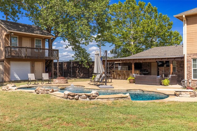 view of pool with a bar, a patio, a lawn, and pool water feature