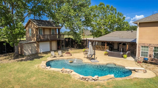 view of swimming pool with a patio, a yard, and a diving board