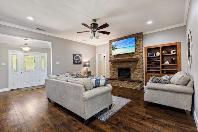 living room with ceiling fan, a stone fireplace, ornamental molding, and dark wood-type flooring