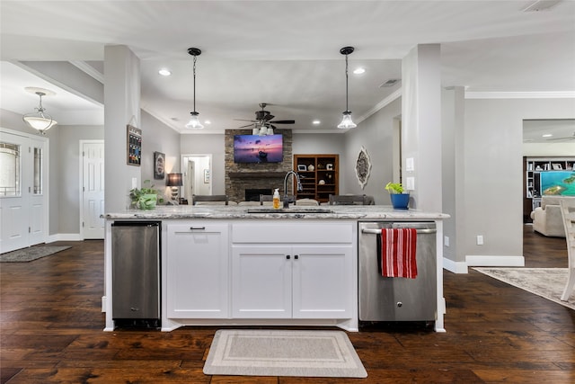 kitchen with sink, dishwasher, pendant lighting, and dark hardwood / wood-style floors