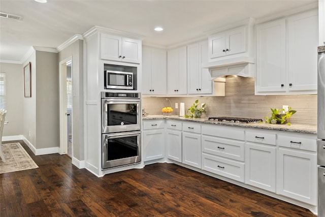 kitchen with stainless steel appliances, backsplash, dark hardwood / wood-style floors, custom exhaust hood, and white cabinetry