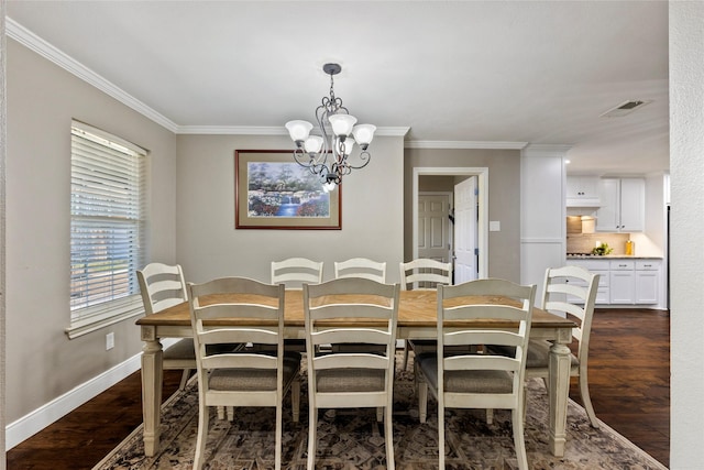 dining area featuring visible vents, a chandelier, crown molding, and dark wood finished floors