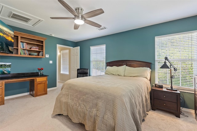 bedroom featuring baseboards, visible vents, and light carpet
