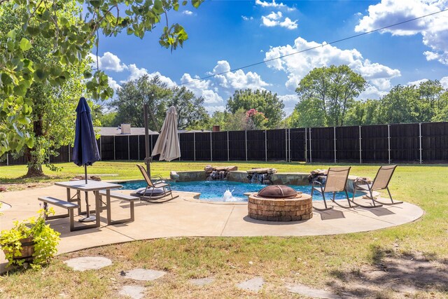 view of pool featuring a lawn, an outdoor fire pit, a fenced backyard, and a patio area