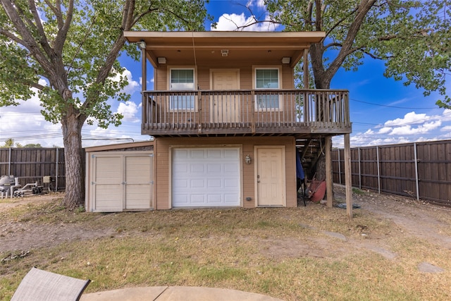 rear view of property with a garage