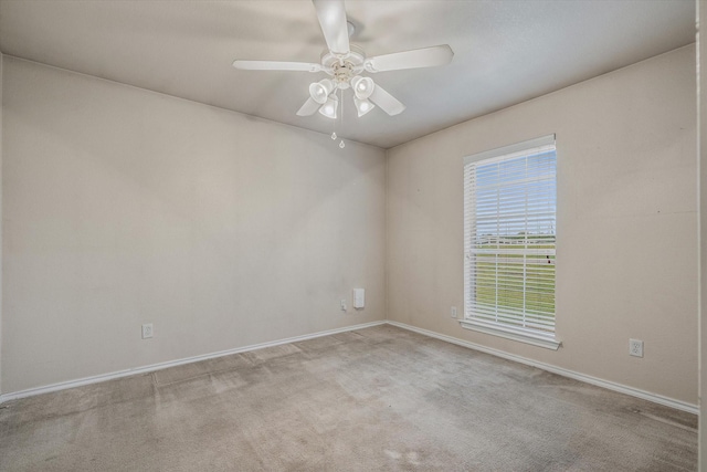 carpeted spare room with ceiling fan