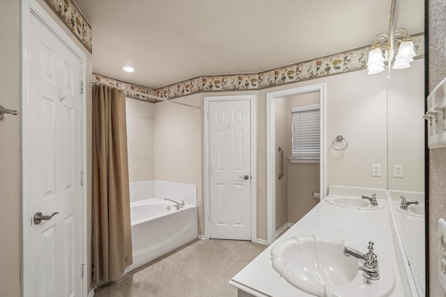 bathroom featuring vanity and a washtub