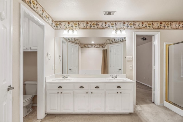 bathroom with toilet, a shower with door, and vanity