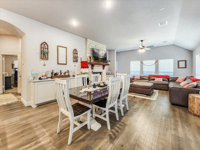 dining space featuring light hardwood / wood-style floors, ceiling fan, and lofted ceiling