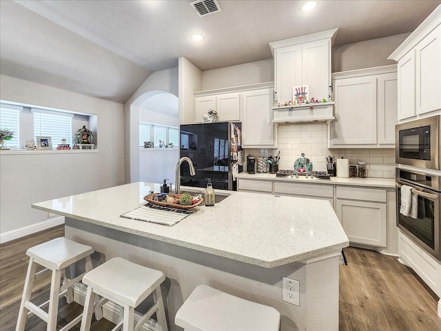 kitchen with white cabinetry, an island with sink, and appliances with stainless steel finishes