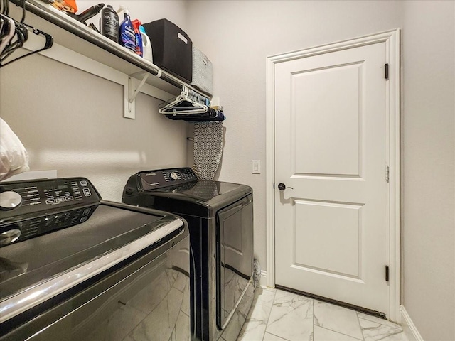 clothes washing area with washing machine and dryer