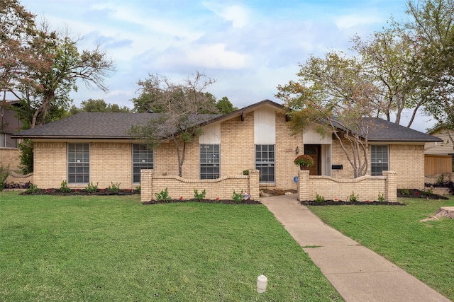 ranch-style home with a front lawn