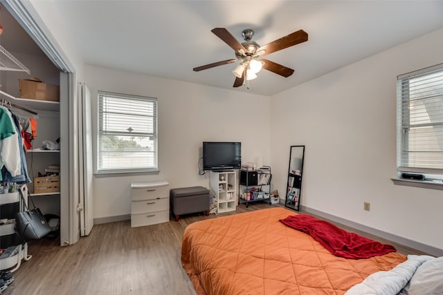 bedroom with wood-type flooring and ceiling fan