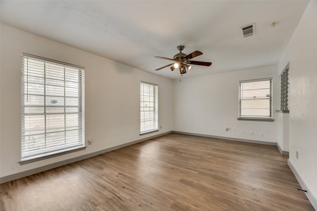 spare room featuring hardwood / wood-style floors and ceiling fan