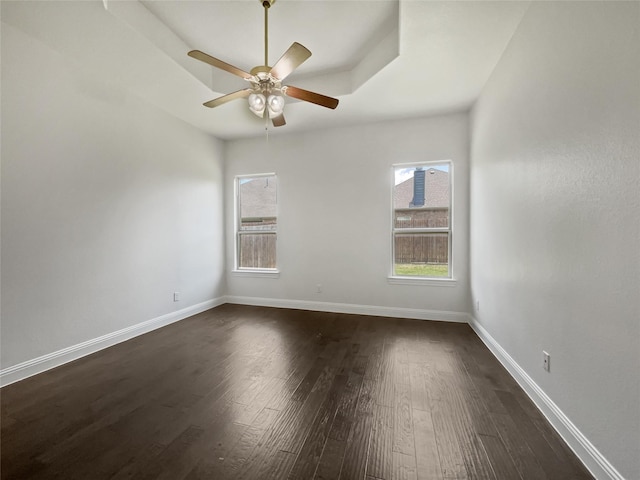 empty room featuring dark hardwood / wood-style floors and ceiling fan