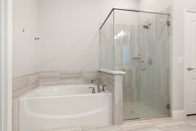 bathroom with tile patterned floors and separate shower and tub