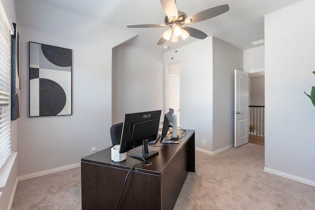 home office with light colored carpet, a wealth of natural light, and ceiling fan