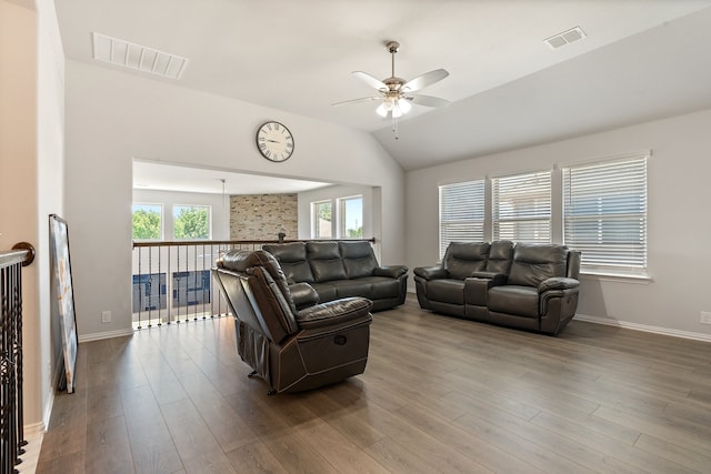 living room featuring lofted ceiling, hardwood / wood-style floors, and ceiling fan