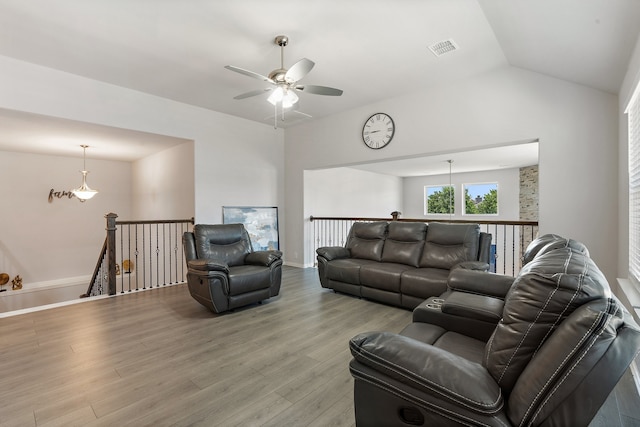 living room featuring vaulted ceiling, light wood-type flooring, and ceiling fan