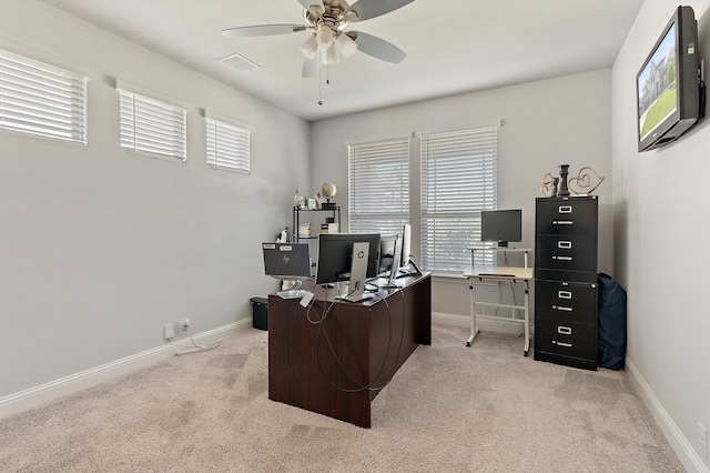 home office featuring light carpet and ceiling fan