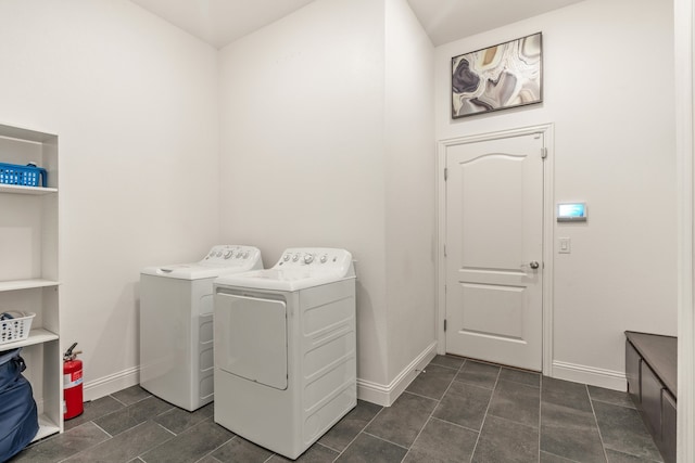 washroom featuring washing machine and clothes dryer and dark tile patterned floors