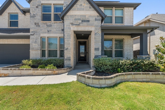 view of front of home featuring a garage and a front yard