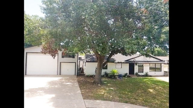 view of front of home with a garage and a front yard