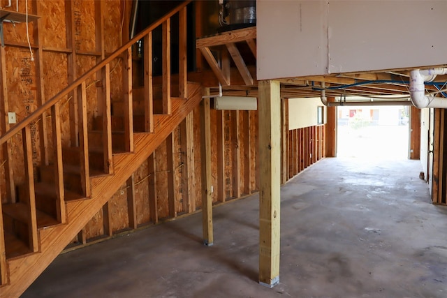 interior space featuring stairs and unfinished concrete flooring