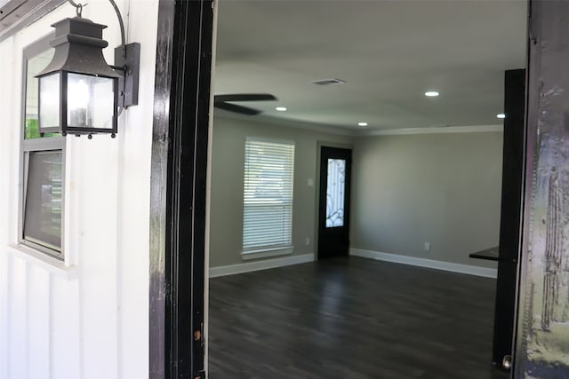 interior space featuring dark hardwood / wood-style floors and ornamental molding